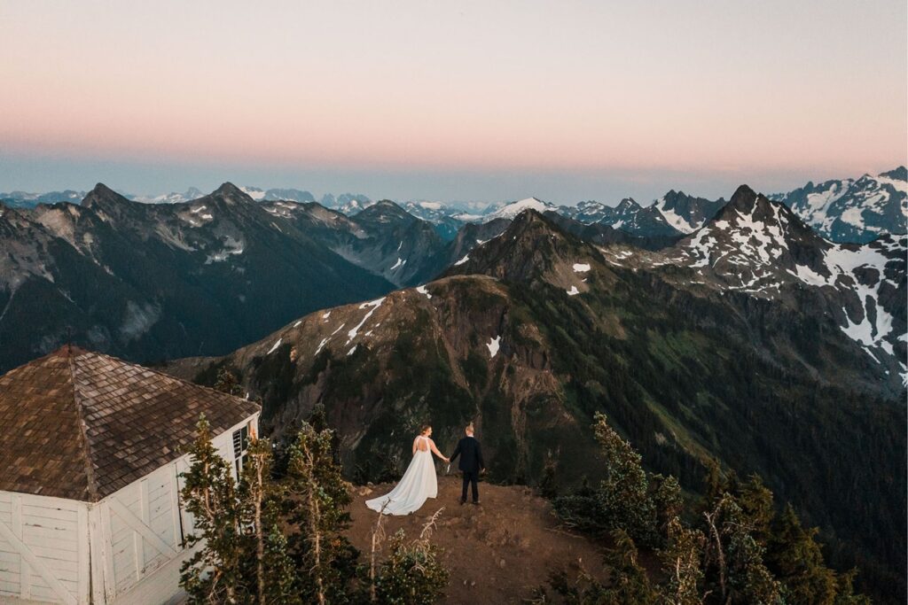 Bride and groom hold hands during their Washington mountain elopement