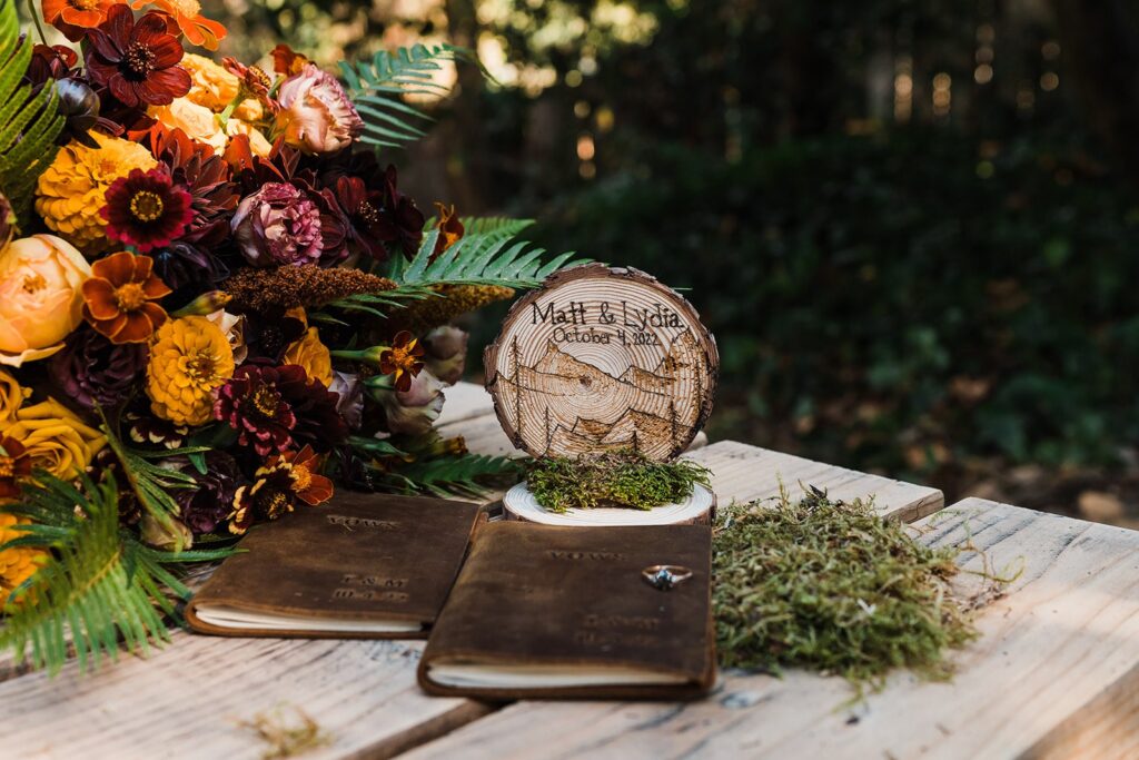 Wood elopement size with leather vow books and fall wedding flowers
