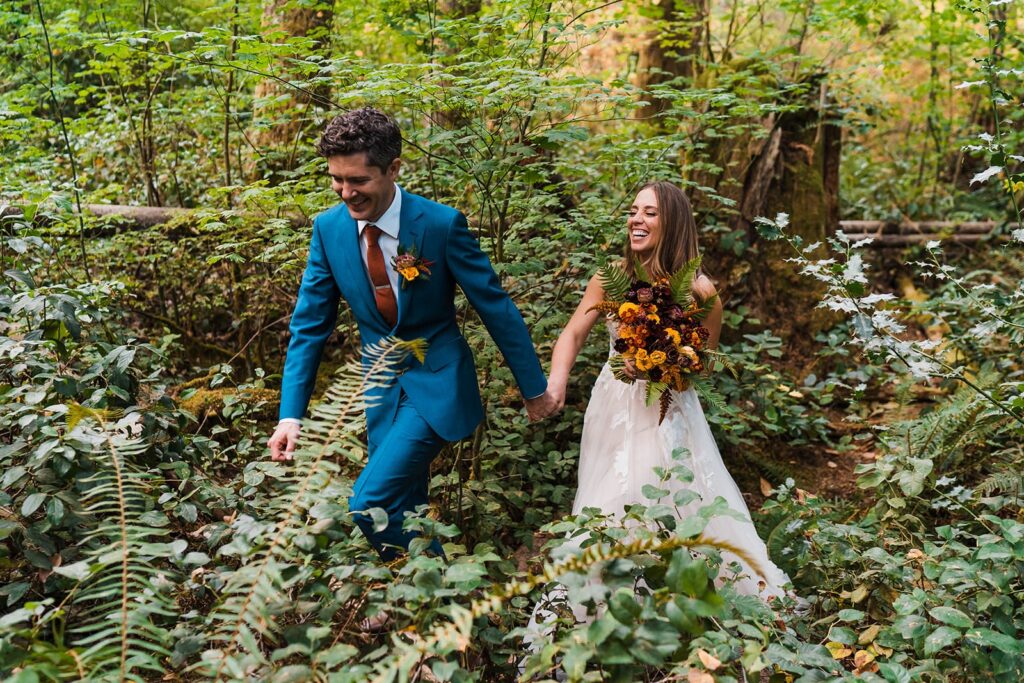 Bride and groom hike through the forest in Snoqualmie Pass for their elopement in Washington
