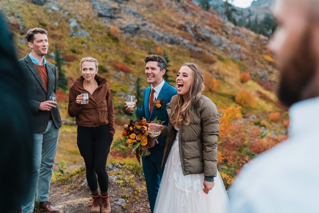 Bride and groom drink and talk with friends after their Washington elopement at Snoqualmie Pass
