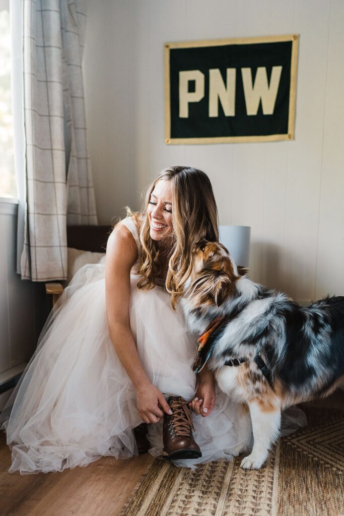 Bride putting on leather hiking boots for her adventure elopement in Washington