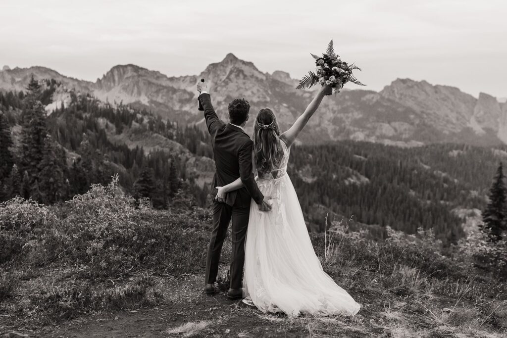 Bride and groom cheer at their Snoqualmie Pass elopement in the Washington mountains