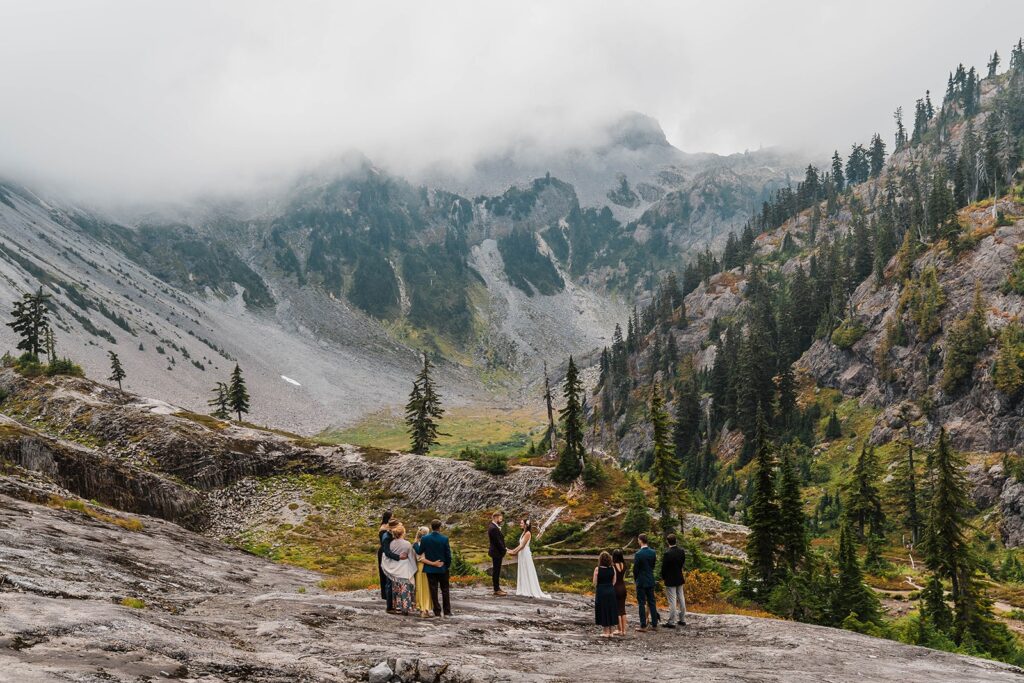 Bride and groom holding hands during outdoor elopement ceremony in the North Cascades