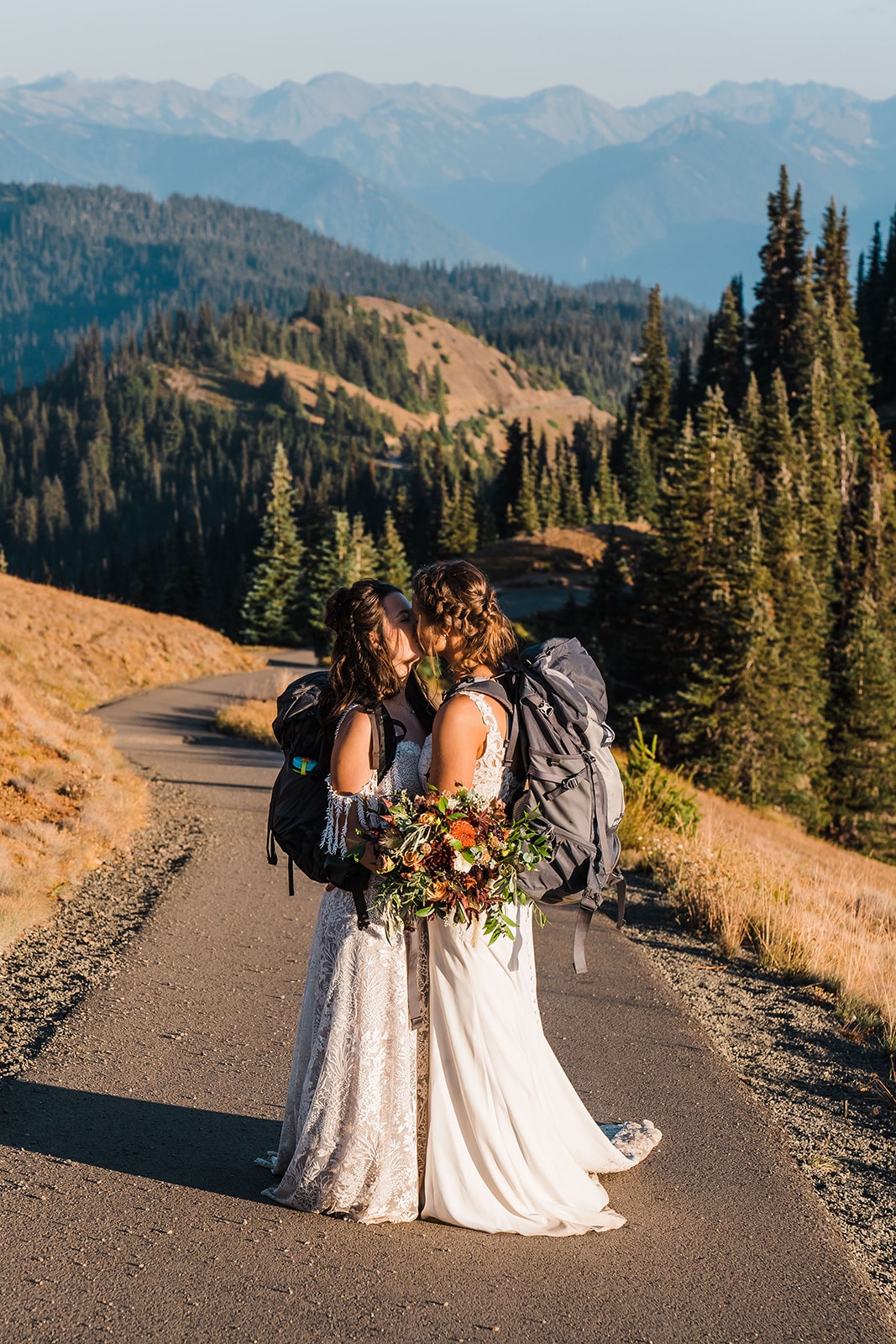 Two brides kiss on a hiking trail during their Washington state elopement on the Olympic Peninsula.