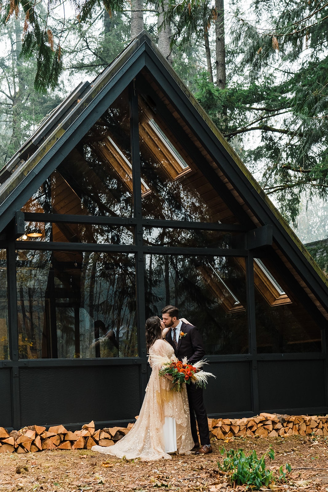 Bride and groom kiss in front of A-Frame cabin during their elopement in Snoqualmie, one of the best Washington State elopement locations.