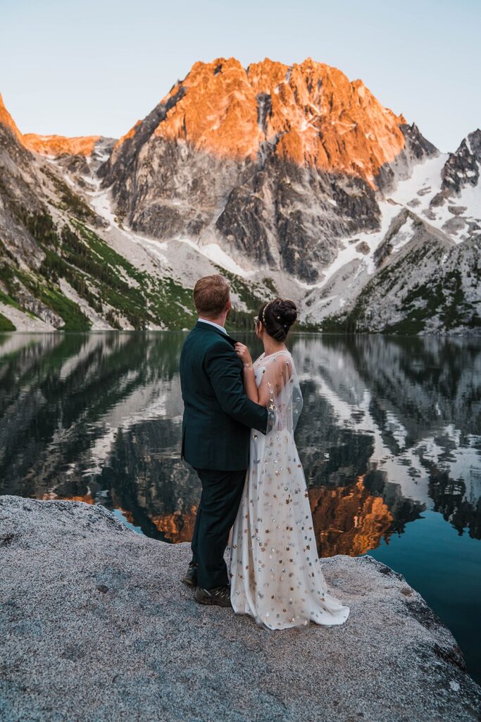 Couple hugging and looking out at the lake and mountains during their Washington state elopement in Leavenworth