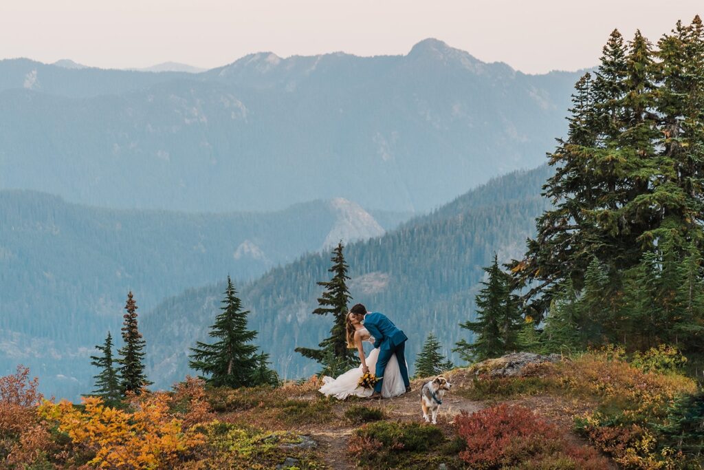 Bride and groom dip for a kiss in the mountains in Snoqualmie Pass during their Washington state elopement