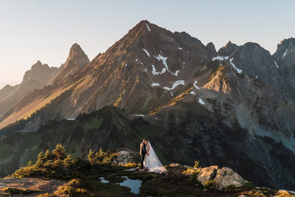 Bride and groom kiss in the North Cascades during their mountain elopement in Washington