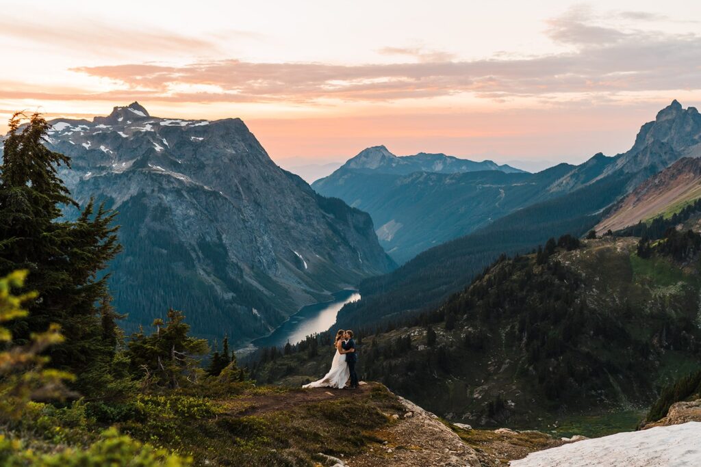 Bride and groom kiss on top of the mountains during their North Cascades elopement