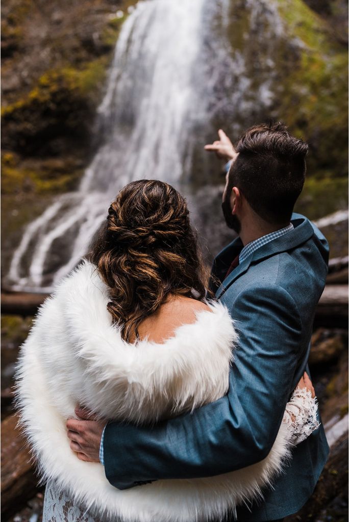 Bride and groom explore Marymere Falls at their spring elopement in Washington