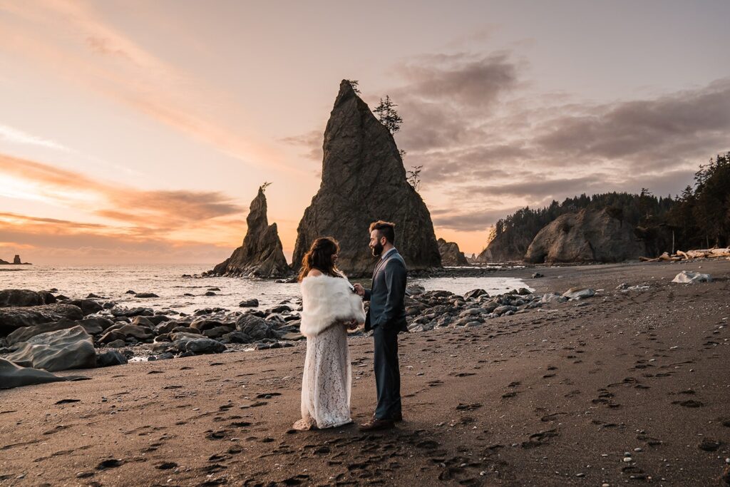 Bride and groom exchange vows on Rialto Beach during their sunset elopement ceremony