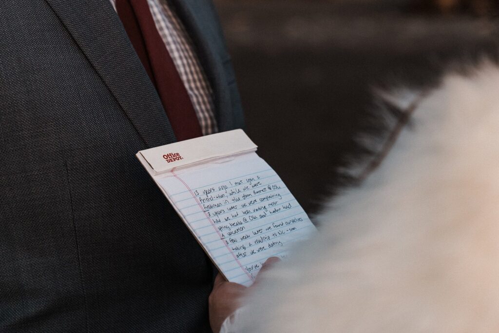 Bride reads personal vows off a memo pad during their spring elopement on the Olympic Peninsula