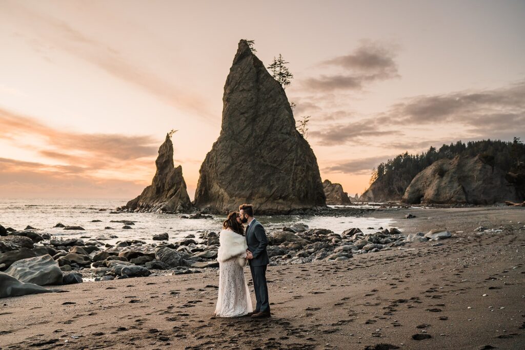 Bride and groom kiss during their spring elopement ceremony on Rialto Beach