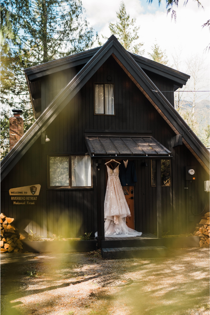 The Riverbend Retreat cabin in Snoqualmie with wedding attire hanging on the front door