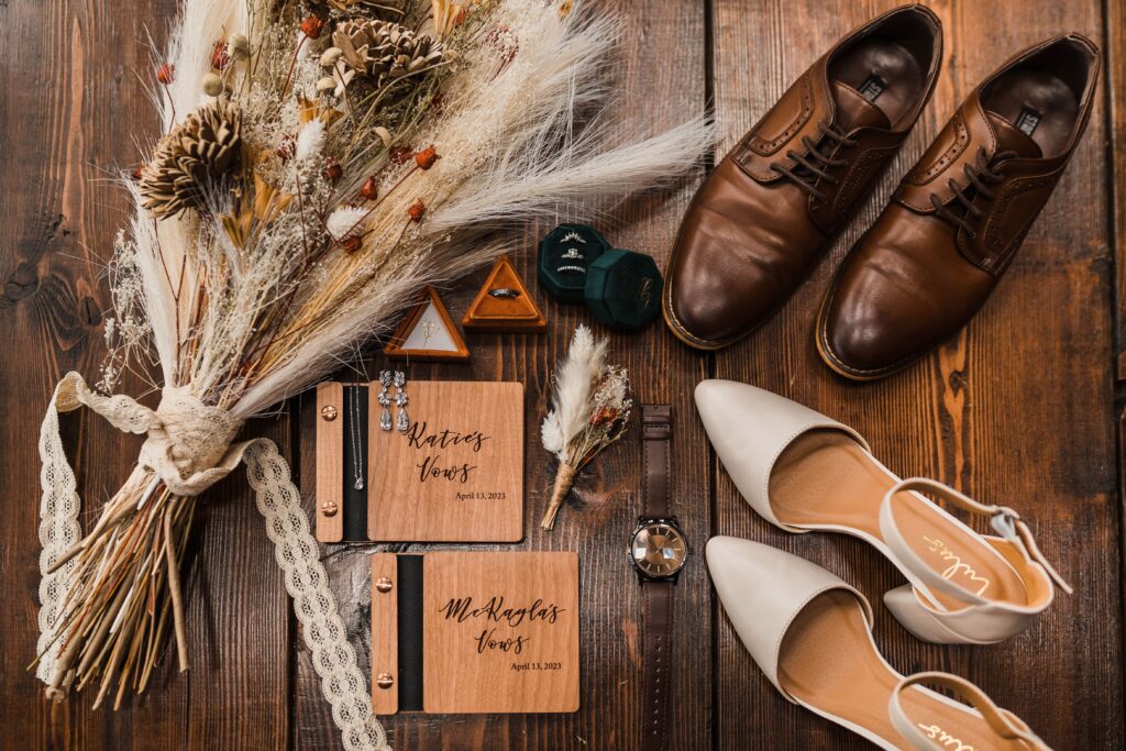 Adventure wedding details with wood vow books and dried flowers