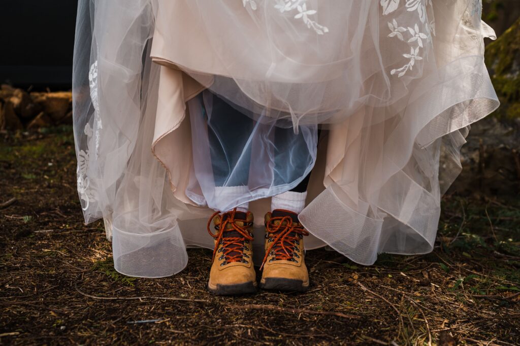 Bride wearing hiking boots with wedding dress