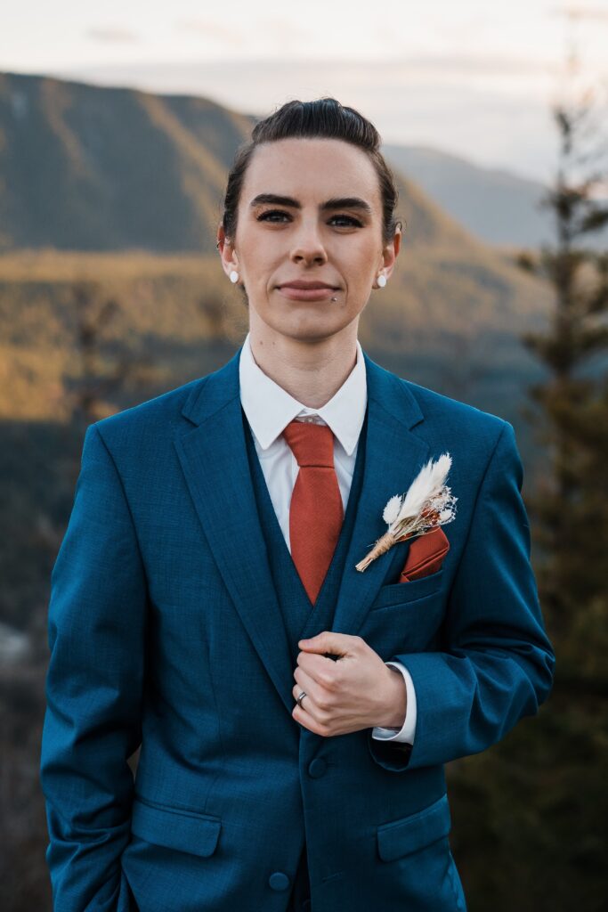 Bride wearing blue suit wedding on top of a mountain in Snoqualmie
