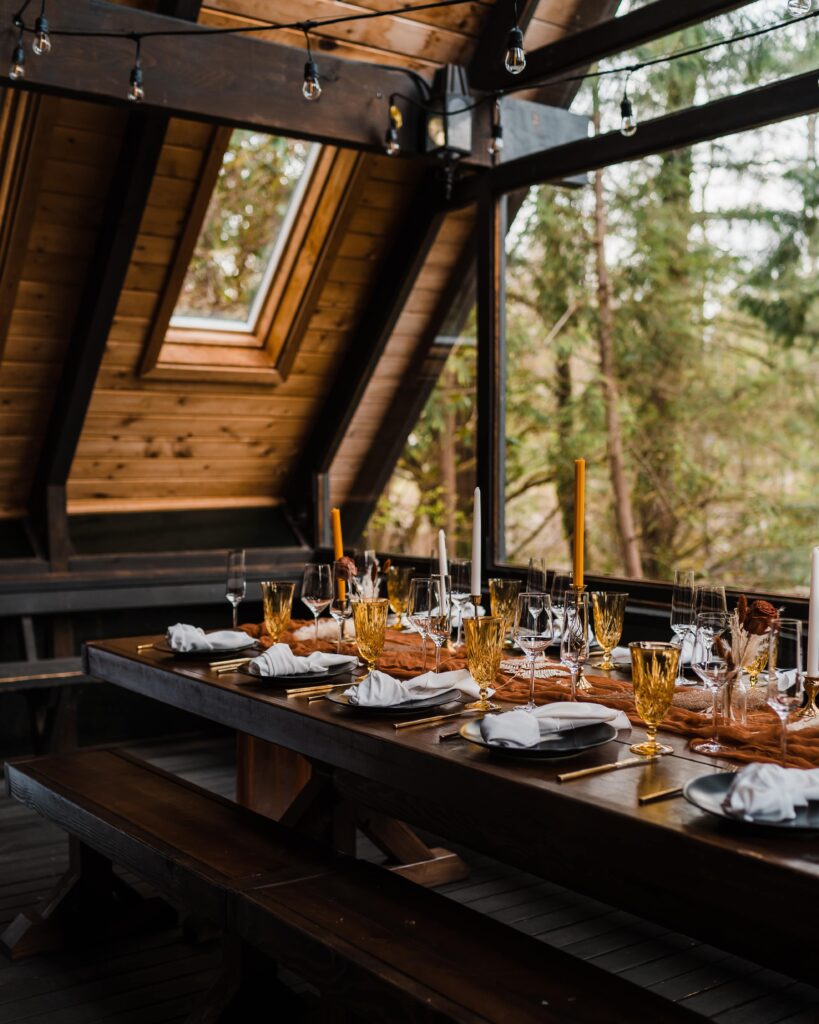 Orange and yellow adventure wedding reception table decor at Airbnb cabin