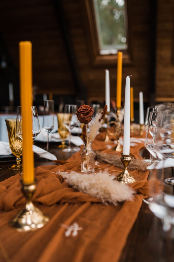 Orange and yellow adventure wedding reception table decor at Airbnb cabin
