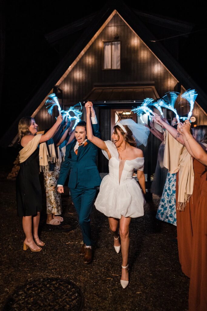 Brides cheer during their adventure wedding exit