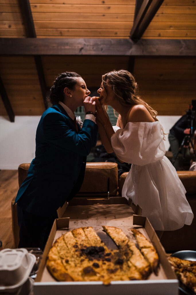 Brides eat vegan pizza after their adventure wedding in Snoqualmie