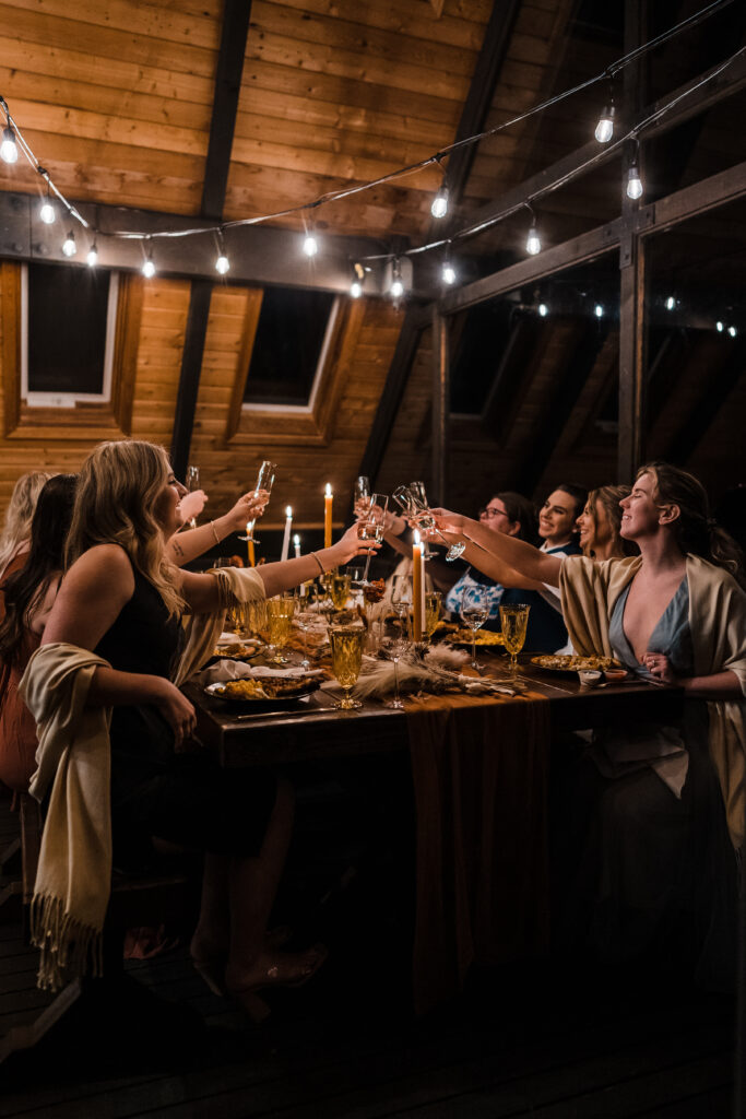 Brides and friends toast at the reception after their adventure wedding in Snoqualmie