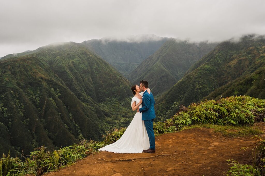 Bride and groom kiss during their Maui elopement photos in the mountains