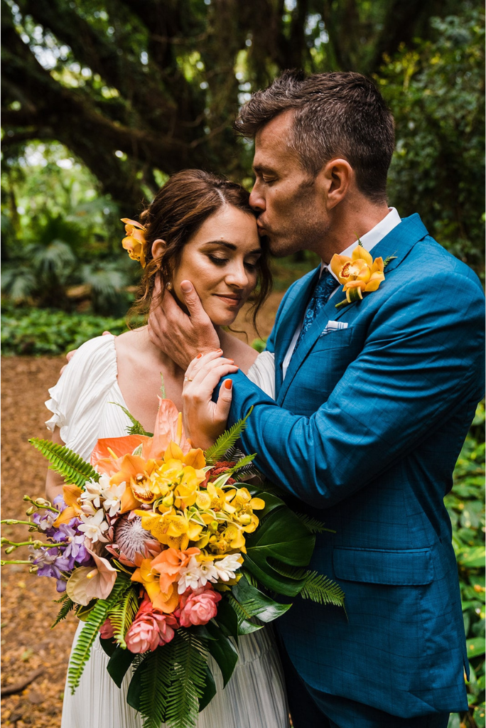 Bride and groom kiss in the rainforest during their elopement in Maui