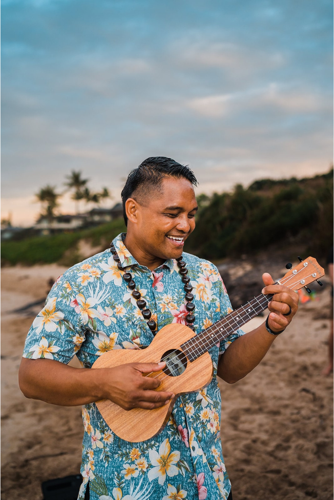 Officiant plays ukulele after beach elopement in Maui