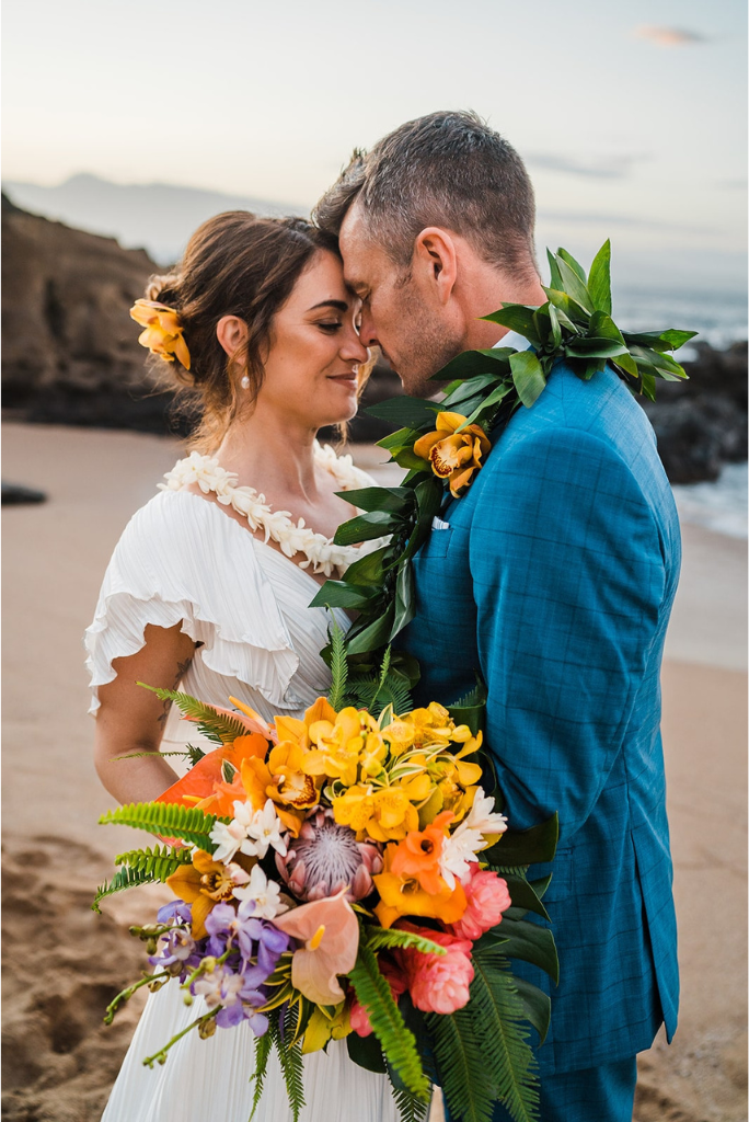 Bride and groom couple photos on the beach at their Hawaii elopement