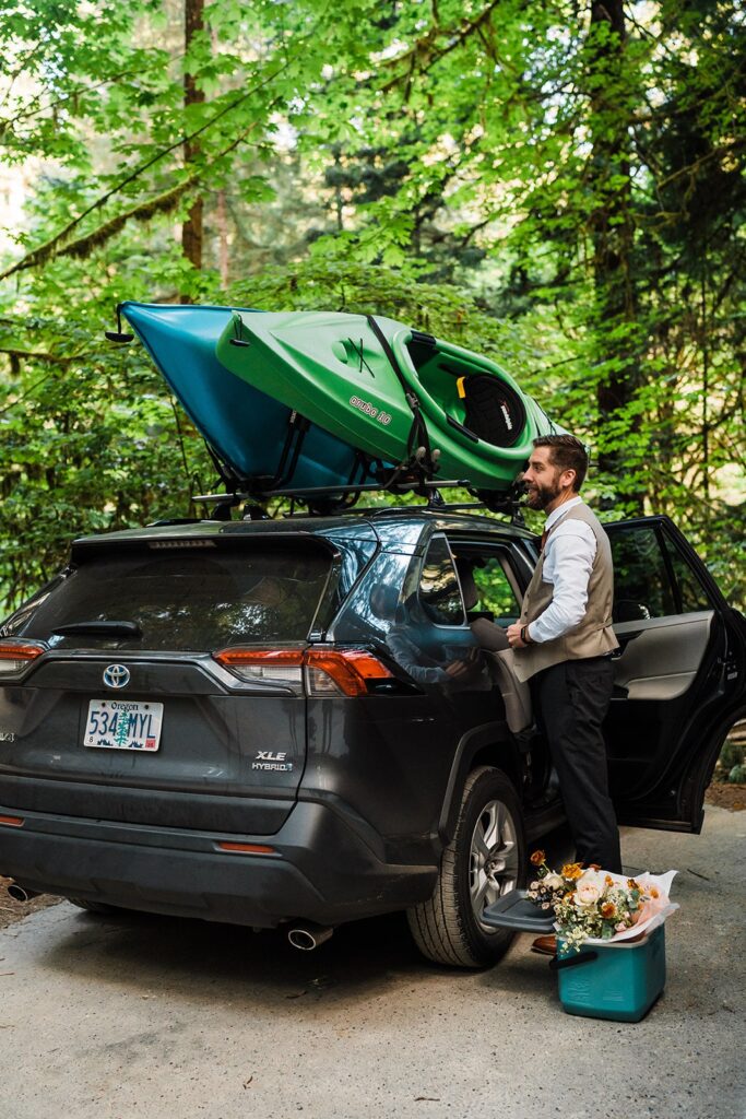 Groom getting ready by the car for Redwoods elopement at Jedediah Smith Redwoods State Park