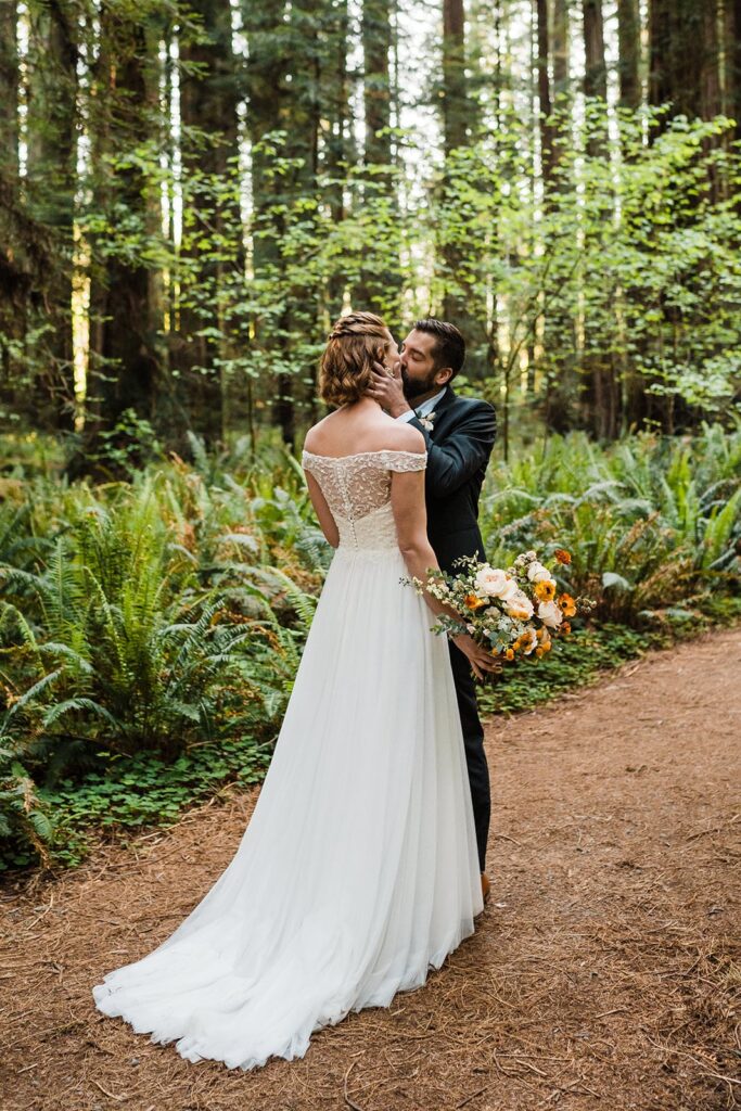 Bride and groom kiss after first look at their Redwoods elopement in California 