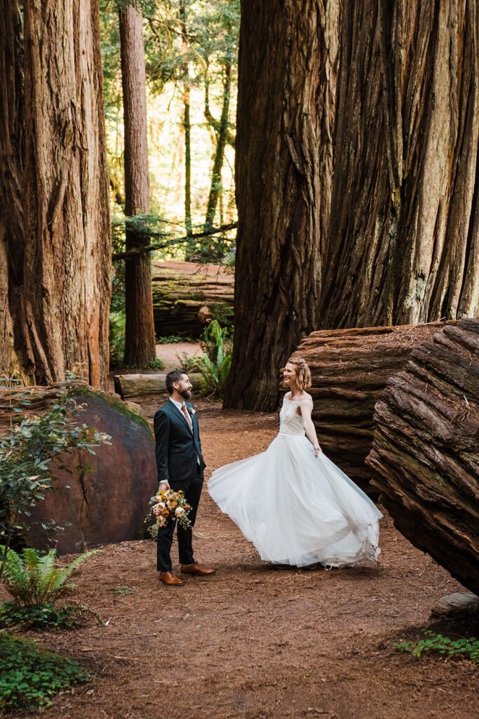 Bride twirls in her white wedding dress at Jedediah Smith Redwoods State Park elopement