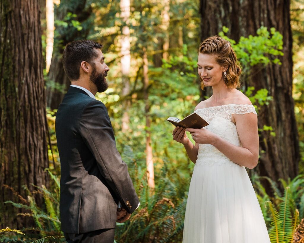 Bride reads vows from brown leather bound vow book