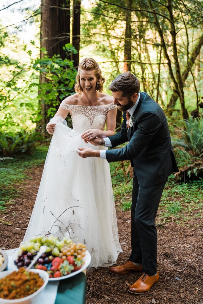 Groom picks sticks out of bride's white wedding dress