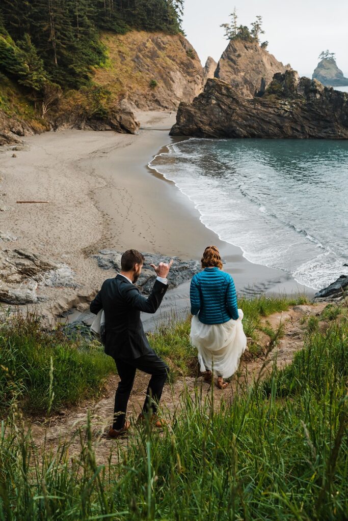 Bride and groom hike down a coastal trail for their wedding photos on the coast