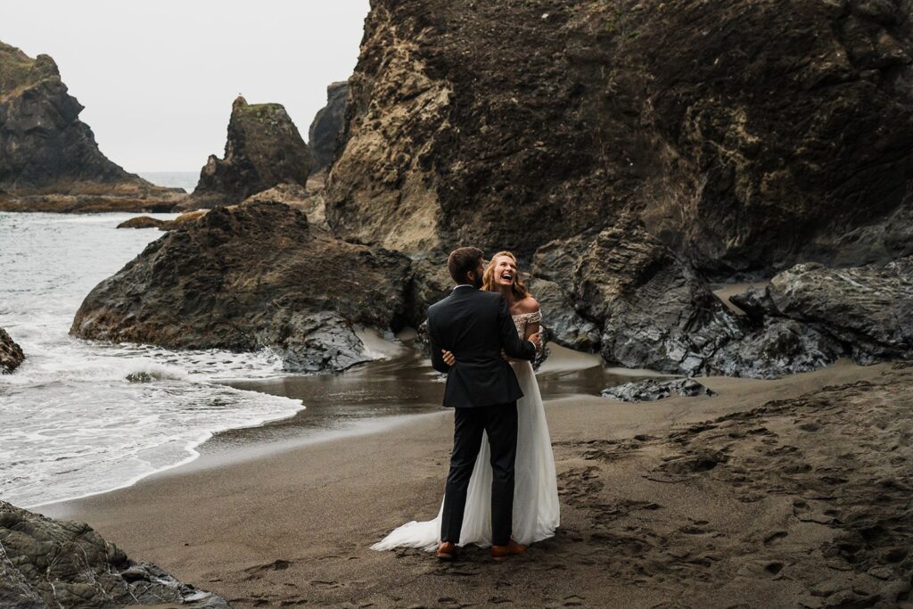 Bride and groom laugh during Oregon Coast elopement photos