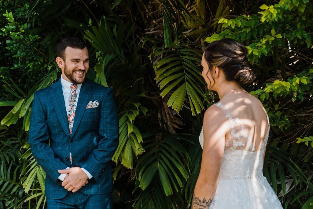 Groom turns around to see bride during wedding first look on Kauai