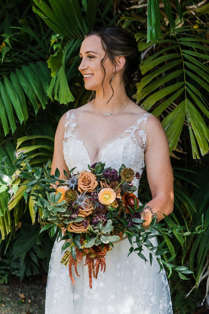 Bride holding bouquet of flowers during wedding portraits in Kauai