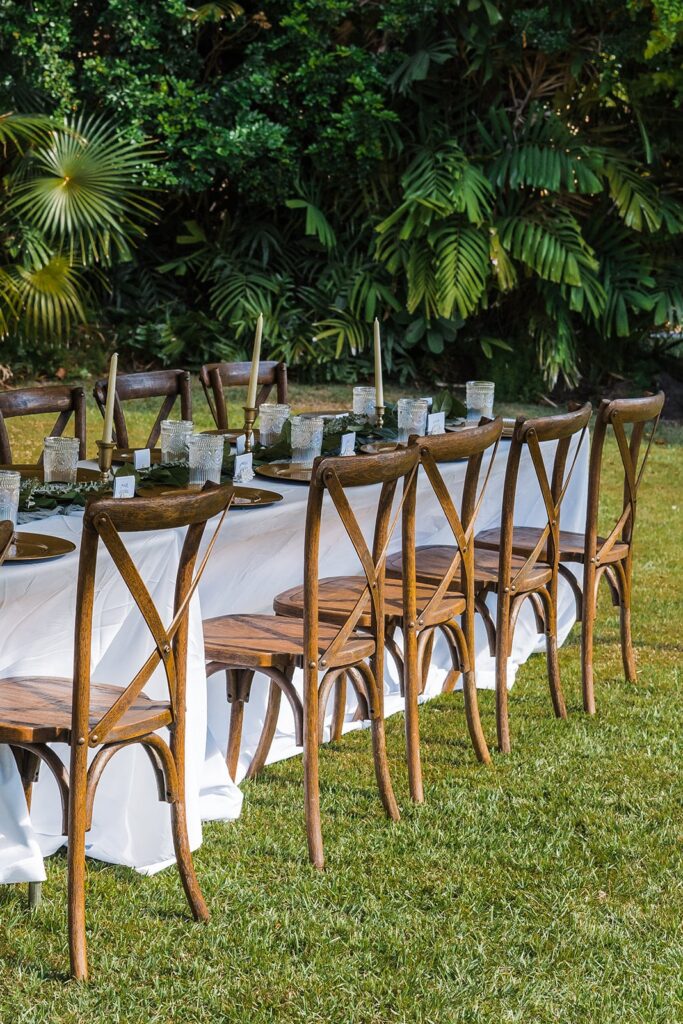 White outdoor reception table with wood chairs