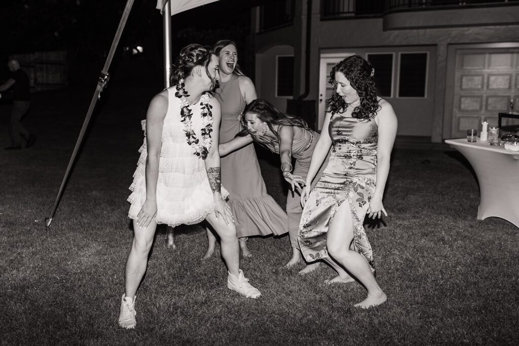 Bride dances with guests at outdoor wedding reception in Kauai