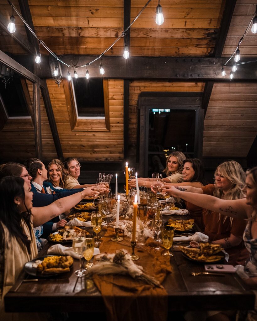 Friends toast over a celebratory meal at their Washington elopement