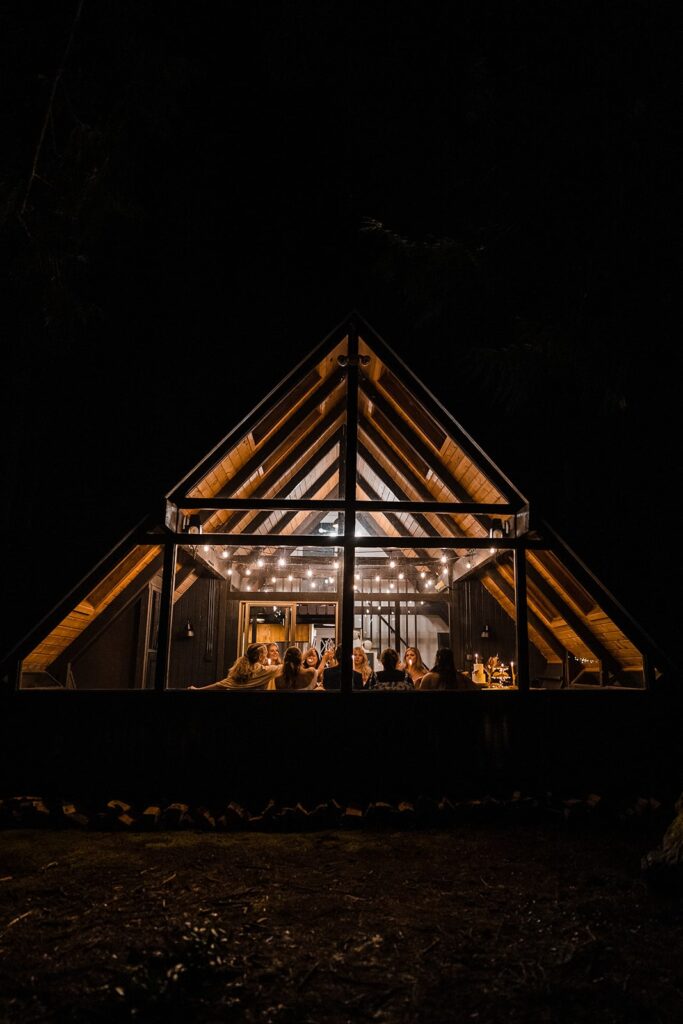 Friends share a celebratory meal in an A-frame cabin in Washington