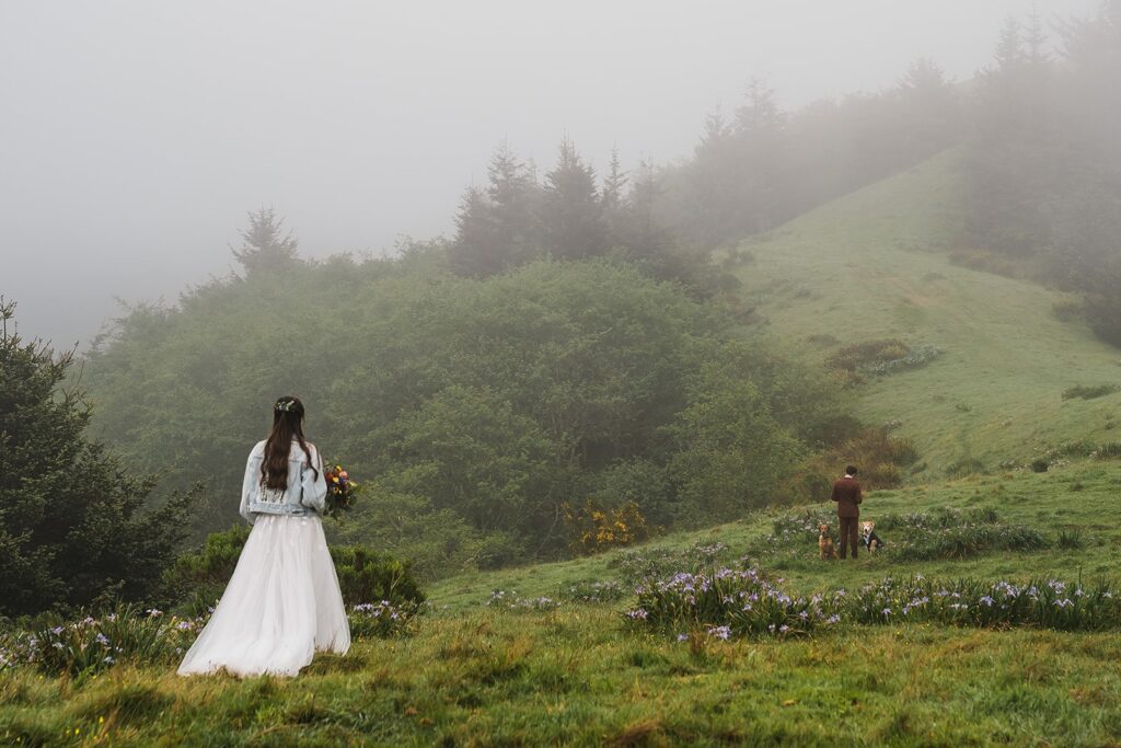 Bride and groom first look during sunrise on a foggy hill at Crook Point elopement 