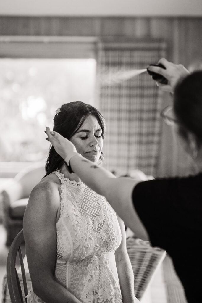 Bride gets hair done at cabin before elopement ceremony on the Oregon Coast 