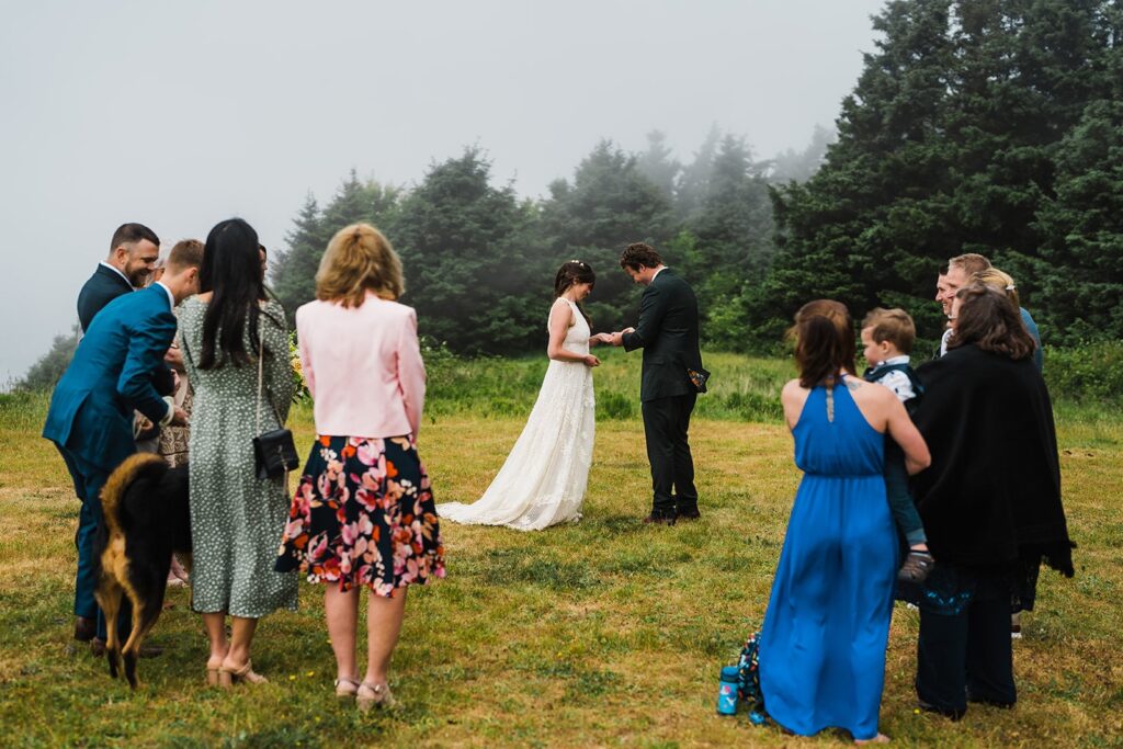 Bride and groom exchange rings during their Oregon Coast elopement 