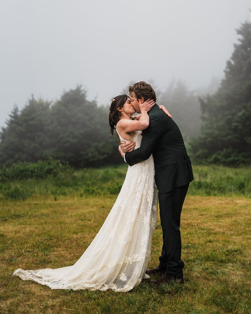 Bride and groom kiss during foggy Oregon Coast elopement ceremony 