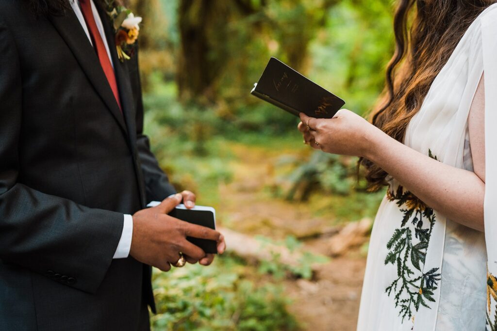 Bride reads from vow book during Hoh Rainforest wedding ceremony