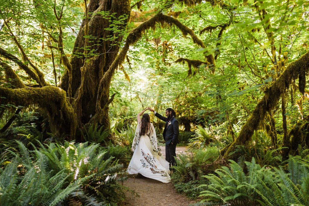 Bride and groom dance under the trees during their Hoh Rainforest wedding