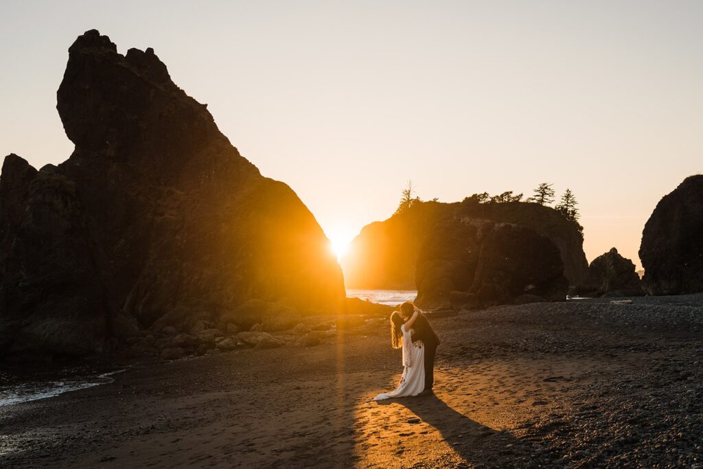 Bride and groom kiss on the beach during their sunset Hoh Rainforest wedding photos